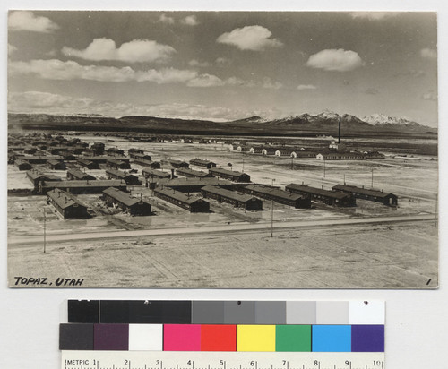 [postcard] [Our concentration camp in Topaz, Utah. The barbed wire fence and guard towers are not visible.] [On verso:] Dec 16, 1944. Mr. and Mrs. Uchida. Our life's memory. Topaz city Utah. Looking down frm 1/2 million gl water tank (Daily usage of amount 150,000 gls.) Height 130 ft. R. Kasai. [NEG available]