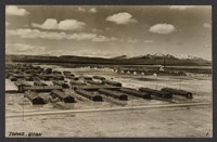 [postcard] [Our concentration camp in Topaz, Utah. The barbed wire fence and guard towers are not visible.] [On verso:] Dec 16, 1944. Mr. and Mrs. Uchida. Our life's memory. Topaz city Utah. Looking down frm 1/2 million gl water tank (Daily usage of amount 150,000 gls.) Height 130 ft. R. Kasai. [NEG available]