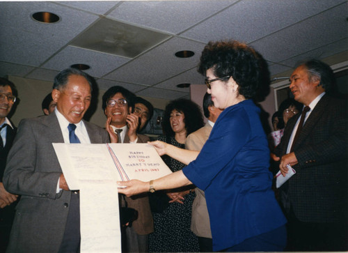 Harry Ueno receiving a birthday card from Hannah Holmes