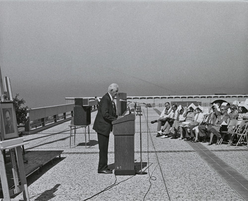 Photograph from the E. Guy Warren Hall Commemorative Dedication Ceremony of Dr. Stafford L. Warren speaking