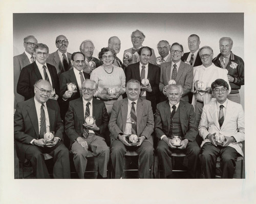 Photograph of group being rewarded for years of service to the university