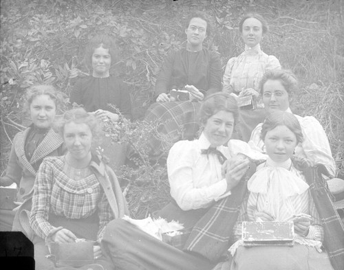 [Group portrait of eight women on a hillside]