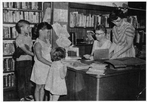 Upland Photograph Public Services; Upland Public Library (Carnegie) two staff members helping 3 children