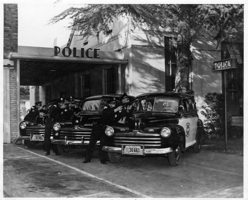 Upland Photograph Public Services; Upland Police Department: police vehicles and police officers at police station