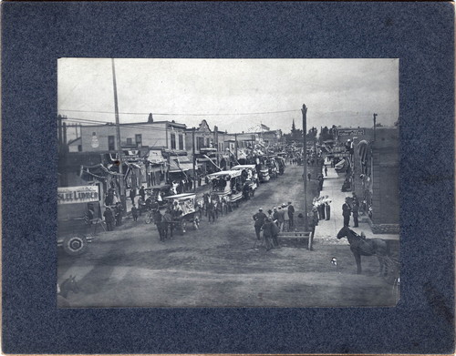 Upland Photograph Events; Fourth of July Parade: horse drawn floats traveling south on unpaved 2nd Avenue, Upland, CA