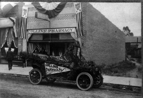 Upland Photograph Events; Parade: automobile decorated with flora and a Collins Pharmacy sign