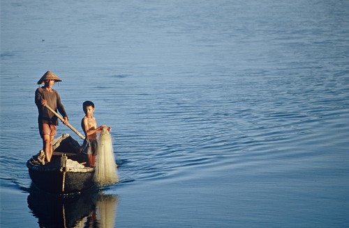 Father and son return home to Lang Co, below the Hai Van ("Sea Clouds") Pass, Thua Thien-Hue Province near Hue