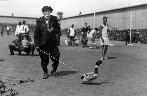 Clown performance featuring a duck, San Quentin Little Olympics Field Meet, 1930 [photograph]