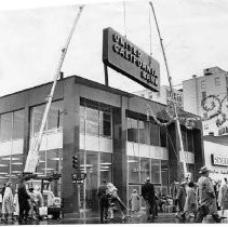 A three ton sign is hoisted atop the new United California Bank Building at the southwest corner of 10th and K Street