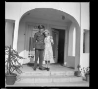 H. H. West, Jr. and Mertie West posing on the front porch of the West's new residence, Los Angeles, 1944