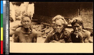 Three elderly women smoking pipes, India, ca.1920-1940
