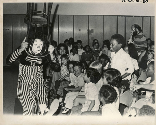 Clown entertaining school children, mid 1970s