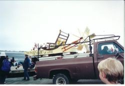 Float labeled 'The Older We Get the Faster We Were' loaded on a pick-up truck at the Fisherman's Festival in Bodega Bay, 1997