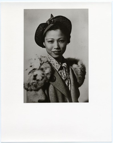 Studio portrait of the young actress Gee Lan Niu of the Great China Theatre company wearing hat and fur collar /