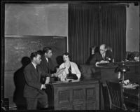 Judge Charles Fricke watches as Joseph Ryan and George Stahlman confer with Nellie May Madison on the stand, Los Angeles County, 1934