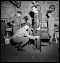 [Ammerschwihr: Secours. Man (amputee) on crutches, perhaps being fitted for an artificial leg]