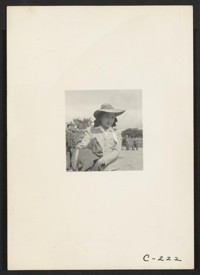 This girl, who worked as a strawberry picker on an Alameda County farm, awaits evacuation bus. Evacuees of Japanese ancestry will be housed in War Relocation Authority centers for the duration. Photographer: Lange, Dorothea Centerville, California