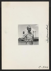 This American soldier of Japanese ancestry is shown at the railroad station of a small town in an agricultural community
