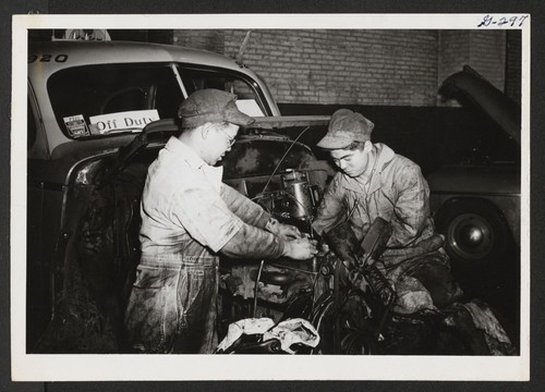 Three of our men have good jobs as mechanics with the Yellow Cab Company. Here Sam Azuma from Colorado River and Mamoru Kiyoka from Jerome try to get a cab marked 'Off Duty' rolling thru the streets of Philadelphia again. Philadelphia, Pennsylvania