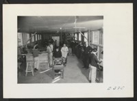 Interior view of the machine shop. (L to R) Ben D. Ramsdell, Instructor; Junidi Amada, William Tak[...] and Nirosh Uyshara, Assistant Instructors in the Tool Shop. George Ota, Machinist. Photographer: Parker, Tom McGehee, Arkansas
