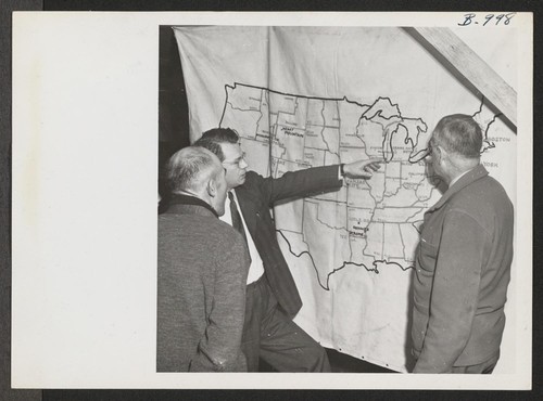 Harold Fistere, Relocation Supervisor from Cleveland, and Elmer Shirrell, Relocation Supervisor from Chicago, discuss their respective areas with an evacuee during a recent visit of a Relocation Team to Rohwer Relocation Center. Photographer: Van Tassel, Gretchen McGehee, Arkansas