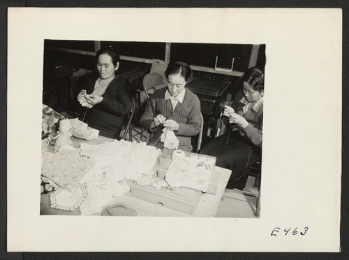 Three members of an adult crocheting class. The instructor (center) teaches students to crochet everything from doilies to lapel trinkets and flower pot covers. Photographer: Parker, Tom Amache, Colorado