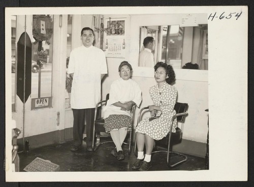 Kyuji Hozaki and his wife Haruyo, from Rohwer, reopen their barber shop in Los Angeles. both are master barbers. Left