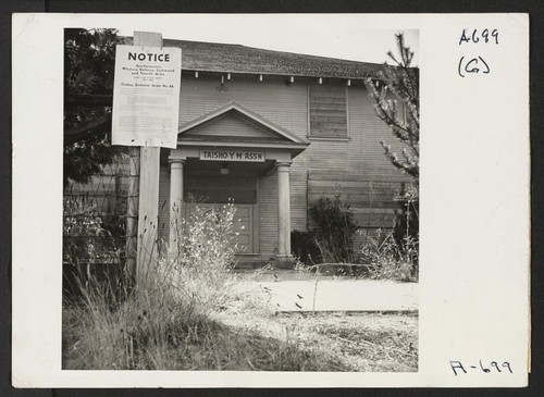 Taisho Y.M. (Young Men) Hall. This hall was a former meeting place for evacuees of Japanese ancestry. It is now used to store evacuee property and is boarded up. Photographer: Stewart, Francis Florin, California