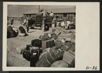 Eden, Idaho--Baggage, belonging to evacuees who have just arrived from the assembly center at Puyallup, Washington, is sorted and trucked to barrack apartments. Photographer: Stewart, Francis Hunt, Idaho