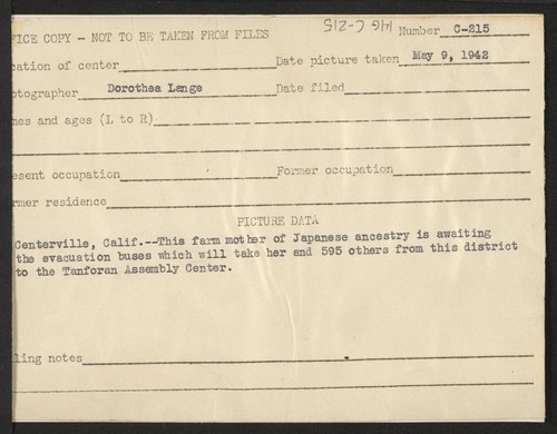This farm mother of Japanese ancestry is awaiting the evacuation buses which will take her and 595 others from this district to the Tanforan Assembly Center. Photographer: Lange, Dorothea Centerville, California