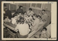 Manzanar, Calif.--Mealtime during early days after evacuation at Manzanar, now a War Relocation Authority center for evacuees of Japanese ancestry. In housing, as well as at meal times, family life is observed. Photographer: Albers, Clem Manzanar, California