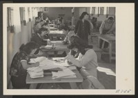In one of the recreation halls at the Granada Center, members of the administration staff register all residents of the