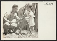 Little Mira Nakashima is following in her father's footsteps as she drives a nail into a piece of wood outside