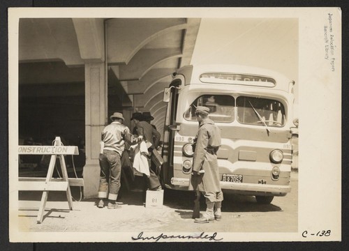 A Greyhound bus bringing evacuees to the assembly center. Photographer: Lange, Dorothea San Bruno, California