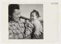 Mrs. Kobayashi and the youngest of her family. Photographer: Parker, Tom Amache, Colorado
