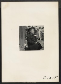 This farm mother of Japanese ancestry is awaiting the evacuation buses which will take her and 595 others from this district to the Tanforan Assembly Center. Photographer: Lange, Dorothea Centerville, California