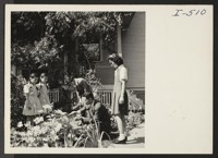 Henry Nomura, voluntary resettler with his family from Oakland, California, is showing his wife, Wakaye, and their three daughters, Judy