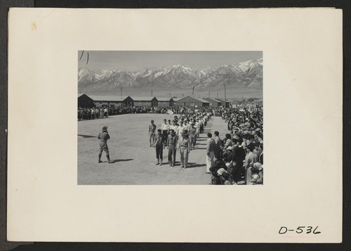 Manzanar, Calif.--Memorial Day services at Manzanar, a War Relocation Authority center where evacuees of Japanese ancestry will spend the duration. American Legion members and Boy Scouts participated in the services. Photographer: Stewart, Francis Manzanar, California