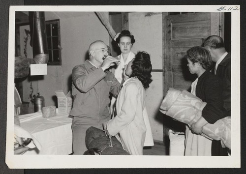 INCOMING--Medical checkup of arrivals at induction station. Photographer: Aoyama, Bud Heart Mountain, Wyoming