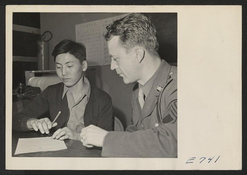 A serious moment for this 21-year-old Japanese-American, for he has just signed voluntary enlistment papers which puts him into a