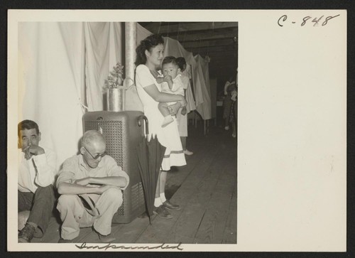 A typical interior scene in one of the barrack apartments at this center. Note the cloth partition which lends a small amount of privacy. Photographer: Lange, Dorothea Manzanar, California