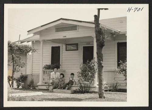 Mrs. Hiroshi Yamao and her children, Frances and Henry, from Heart Mountain, at the home of friends, the S. Imamuras