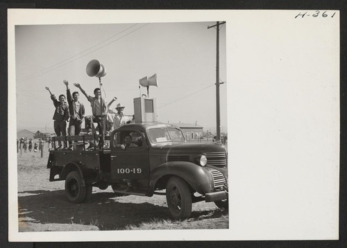 The public address system broadcasts records as trains arrive at and depart from the Tule Lake Center. Operators of the truck wave farewell to former friends entraining at Heart Mountain as the loud speakers carry the strains of Aloha. Photographer: Mace, Charles E