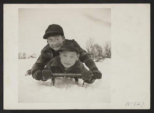 These two boys are rapidly developing a love for a sport which is entirely new to them . . . sledding. (L to R) Toshio Boi, Henry Kumasaka. Present occupation: students. Former occupation: students. Former residence: Seattle, Washington. Photographer: Stewart, Francis Hunt, Idaho