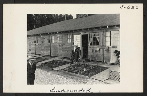 Another view of the barracks, living quarters for families evacuated from San Francisco on April 29. Note the flower garden and numerous evidences of care of their surroundings. These barracks were formerly horse stalls. Photographer: Lange, Dorothea San Bruno, California