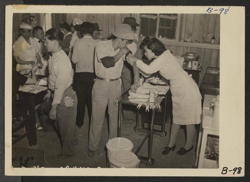 Manzanar, Calif.--Newcomers vaccinated by fellow and sister evacuees of Japanese ancestry on arrival at Manzanar, a War Relocation Authority center. Photographer: Albers, Clem Manzanar, California