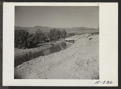 In the foreground can be seen the irrigation canal which will supply Poston with agricultural water. This canal receives its water from the Parker Dam. In the background can be seen the Colorado River. Photographer: Stewart, Francis Poston, Arizona