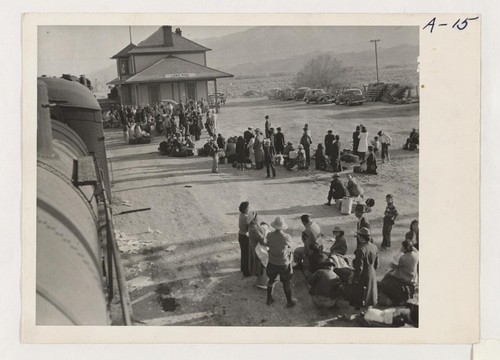 Evacuees of Japanese ancestry waiting to board buses which will take them to the War Relocation Authority center at Manzanar where they will spend the duration. Photographer: Albers, Clem Lone Pine, California