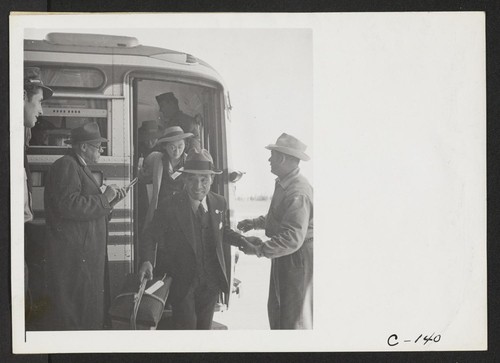 San Bruno, Calif.--Evacuees of Japanese ancestry arriving at the Tanforan Assembly Center. They are being checked as they leave the bus. Photographer: Lange, Dorothea San Bruno, California