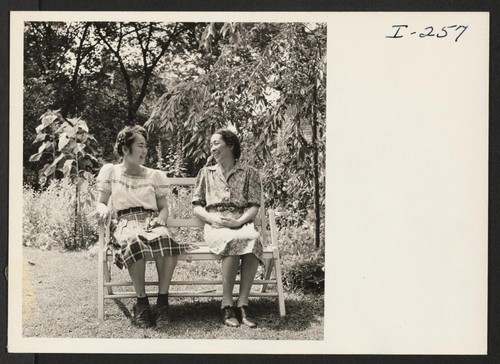 Mrs. Uneyo Ishimoto and her daughter, Carol, in the garden of the home of Mr. and Mrs. Edgar Seeler, Cambridge, Massachusetts. Photographer: Iwasaki, Hikaru Cambridge, Massachusetts